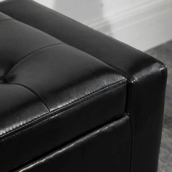 Close-up of black PU leather ottoman with tufted top, stitched seam, and smooth finish