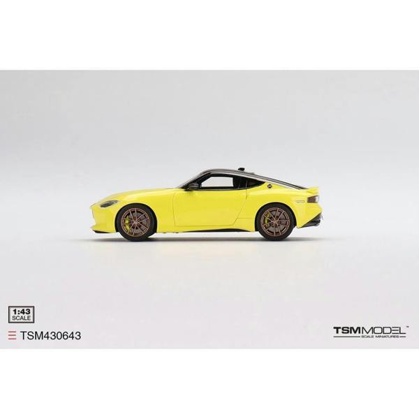 a yellow toy car on a white background