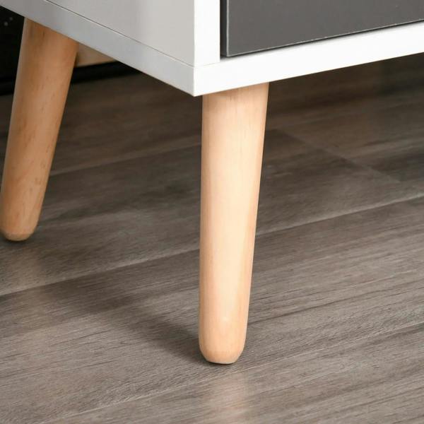 Tapered light wood legs under a white and grey storage cabinet