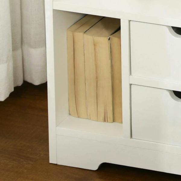 White bedside cabinet showing open cubby for storage and adjacent drawer front