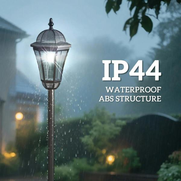 Black solar lantern post light in the rain, glowing through clear glass panels.