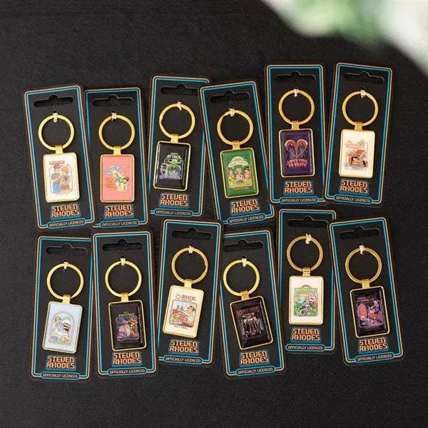 Set of Steven Rhodes recycling keyrings on blue display cards with gold rings