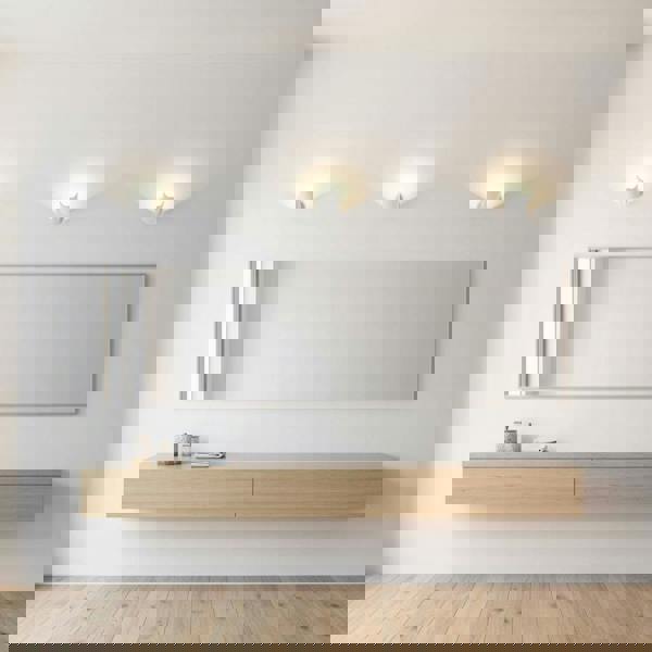 White wall uplighter indoor above a dressing table on  a grey wall in a modern home