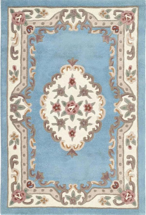 Decorative rug with floral pattern and intricate border on a light blue background
