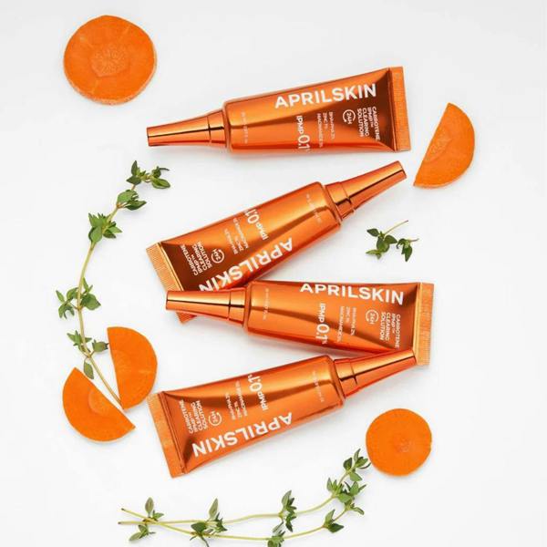 Lightweight, non-flaking clear gel-cream texture of APRILSKIN Carrotene IPMP Clearing Solution absorbing smoothly onto a facial blemish spot at Atelier De Glow UK.