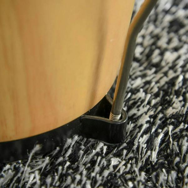 Close-up of bongo drum body and black base foot on a shag rug