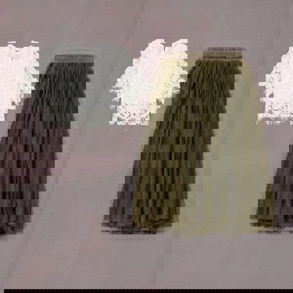 White lace top and green skirt on a gray background