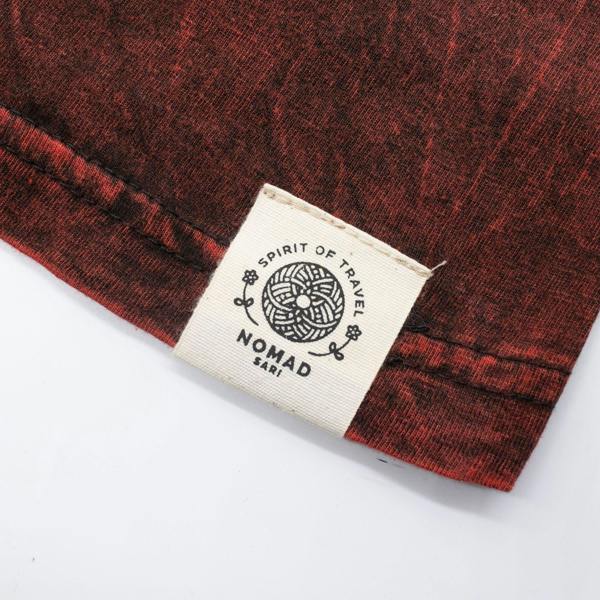 Maroon t-shirt hem with fabric texture and stitched brand label