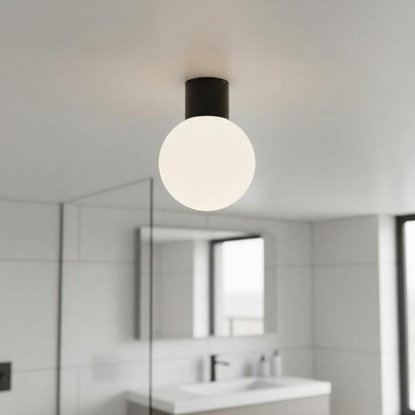 black globe bathroom ceiling light mounted in a modern bathroom 