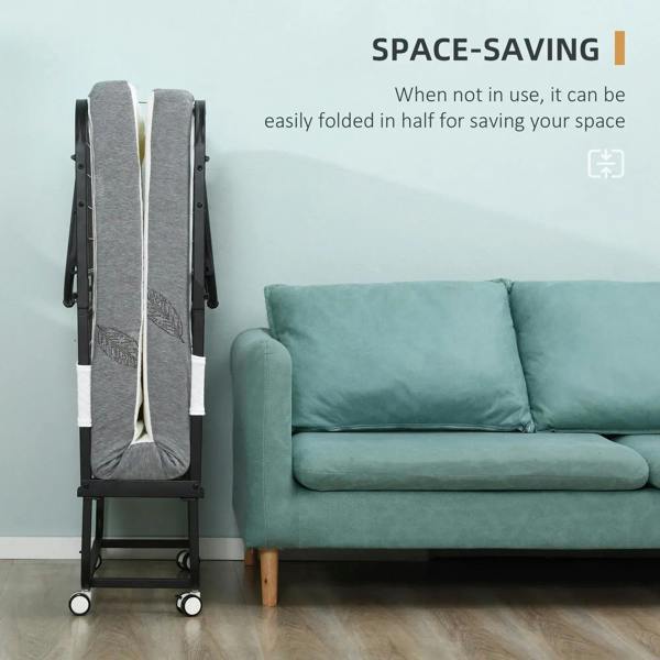 Space-saving folding bed folded in half, gray mattress cover on black metal frame with wheels