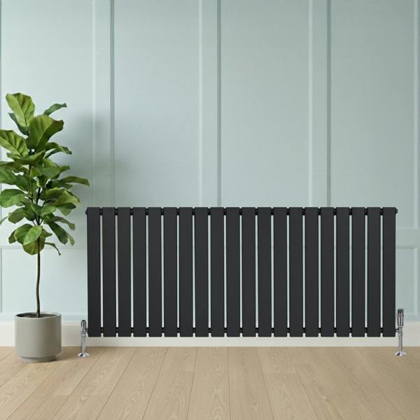 Flat single column radiator in anthracite grey, 600 x 1400mm, with sleek vertical slats, positioned beside a potted plant on wooden floor