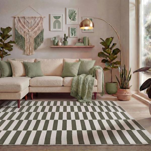 Living room with a beige sectional sofa, green throw blanket, and decorative plants.