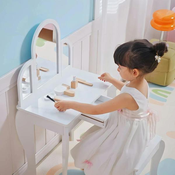 White kids dressing table set with arched mirror, storage shelves, and matching stool
