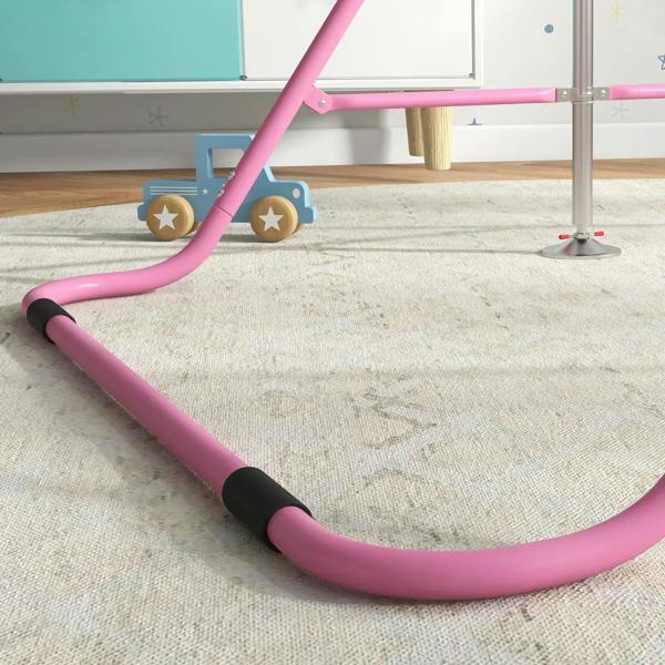 Pink padded base rail of a kids gymnastic bar with black end caps