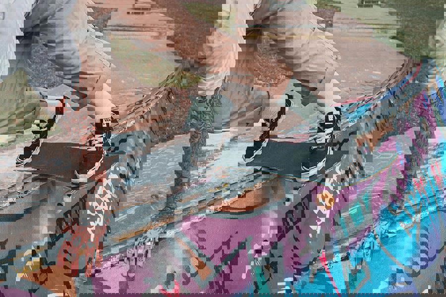 Person skateboarding on a graffiti-covered ledge wearing mint green socks