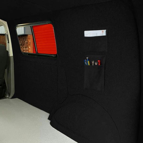 Black storage pouches mounted on a textured wall, featuring organized tools and pens, ideal for maximizing space in vehicles