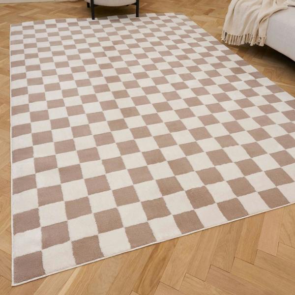 Checkered rug with brown and white squares on a wooden floor