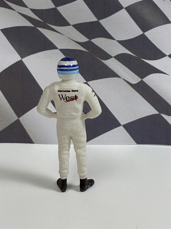a toy figure of a man in a race suit