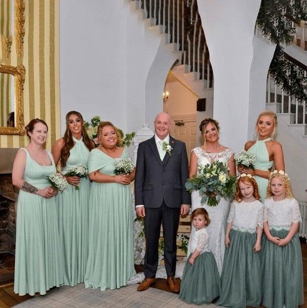 young flower girl at wedding with family
