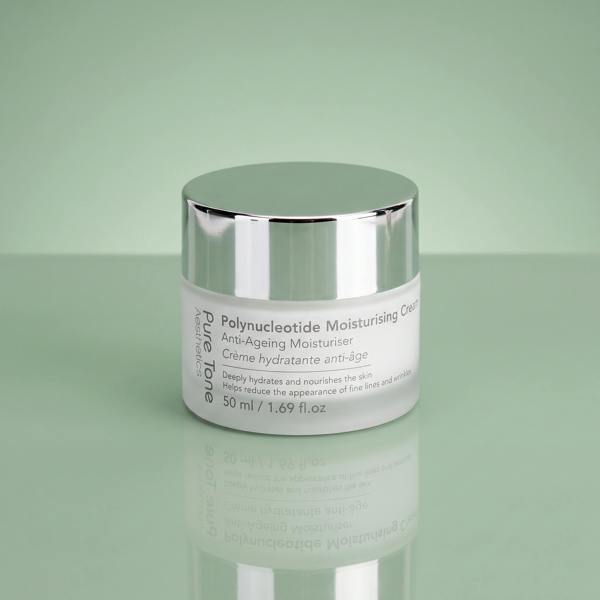 Pure Tone Aesthetics Polynucleotide Moisturising Cream jar with silver lid on a reflective soft green surface