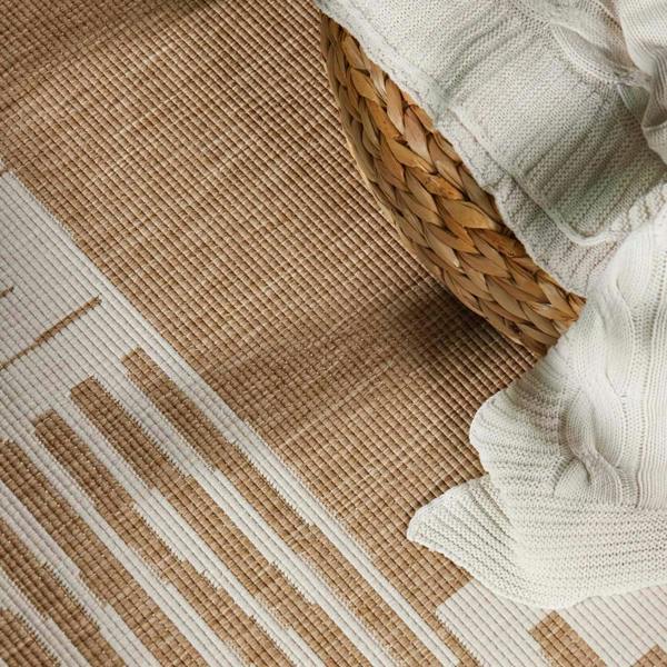Textured brown and beige rug with a woven basket and white fabric.