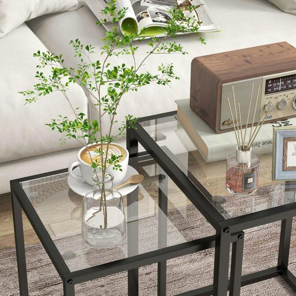 Rectangular black nesting table with clear tempered glass top and open steel frame