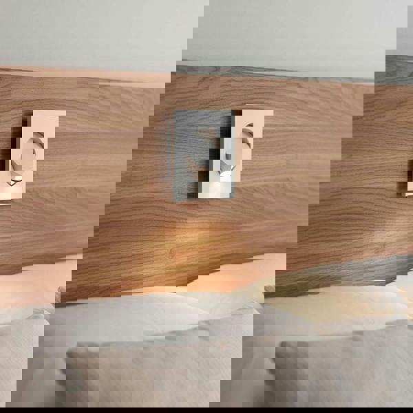 white recessed LED reading light for bed recessed into a wooden bed headboard in a minimailst bedroom