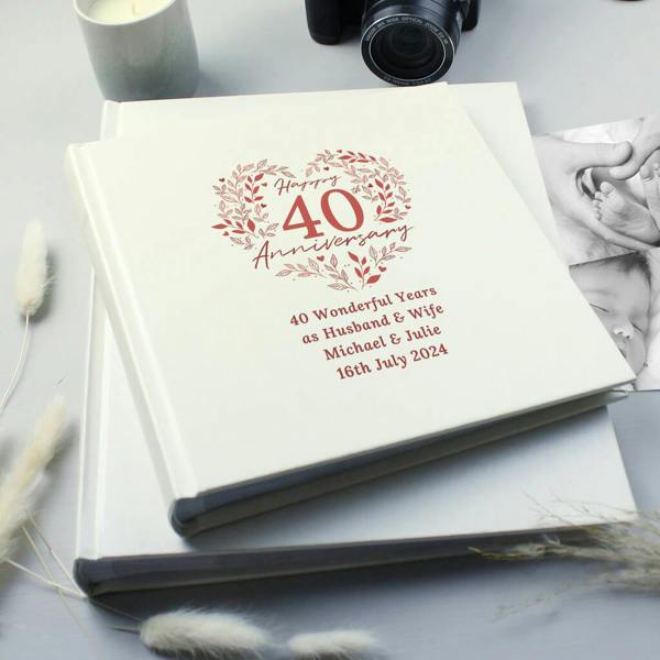 A cream-coloured 40th Ruby Wedding Anniversary photo album with a ruby-red floral heart design, personalised with '40 Wonderful Years as Husband & Wife', 'Michael & Julie', and '16th July 2024'.