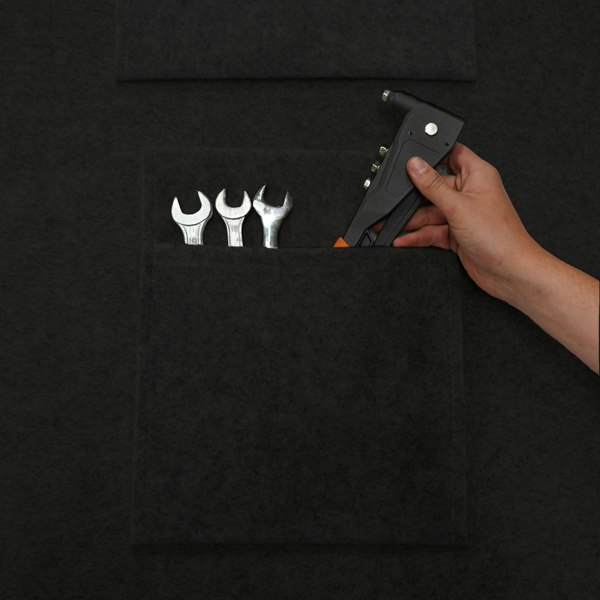 Black storage pouches featuring a textured surface, holding various tools like wrenches and a hand tool for organized storage