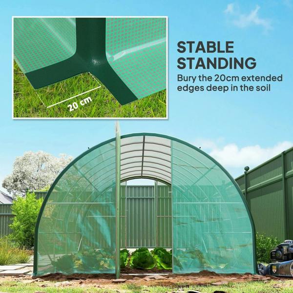 Green walk-in polytunnel greenhouse standing in yard with anchored base