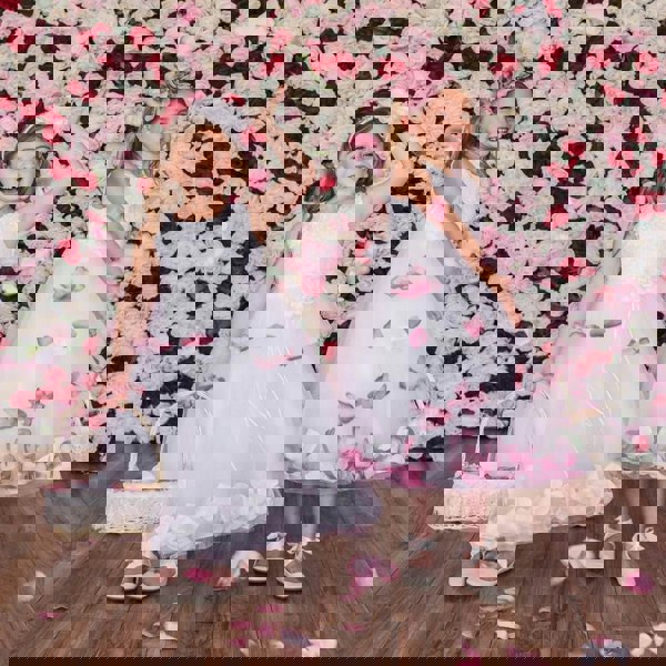 2 girls playing with petals in flower girl dresses