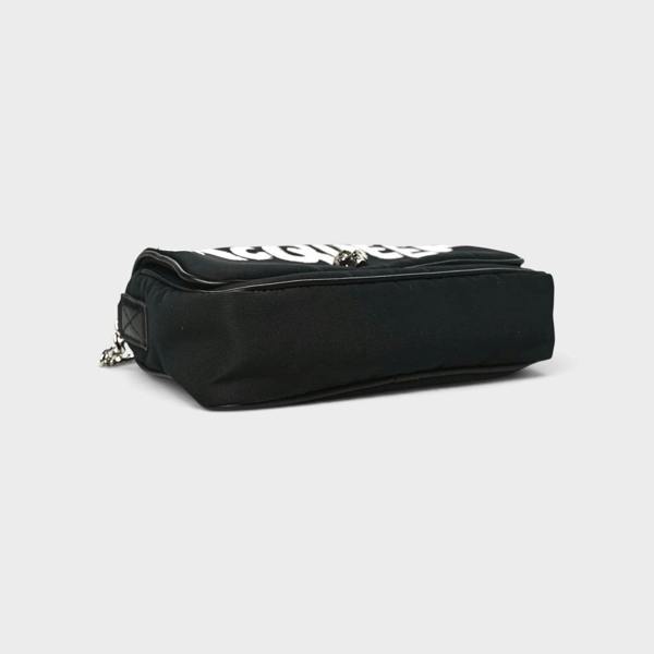 Supplied Fashion black nylon crossbody bag with white graffiti skull logo, side view showing compact design.