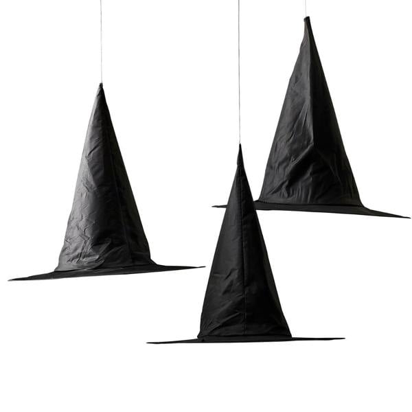 Set of three black floating witch hat decorations suspended on clear twine isolated on a white background