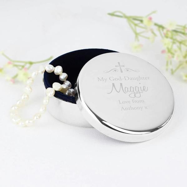 A personalised nickel-plated round trinket box engraved with My Goddaughter Maggie Love from Anthony x next to a pearl bracelet.