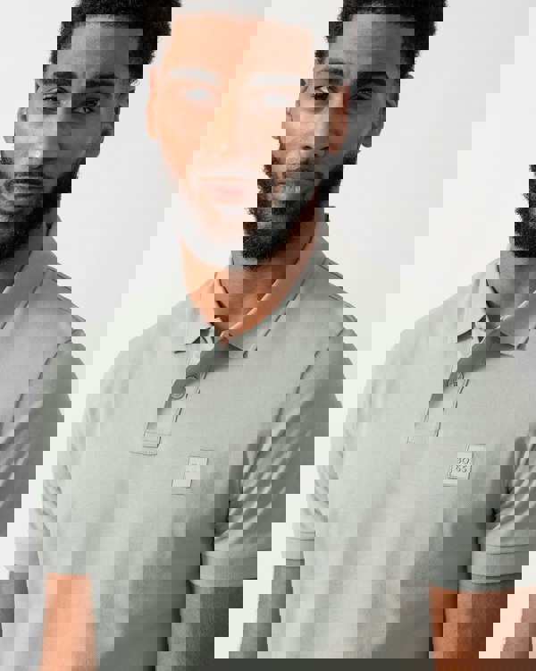 close up of a Model wearing a BOSS Orange Passenger Mens Stretch-Cotton Slim-Fit Polo Shirt with Logo Patch in Open Green