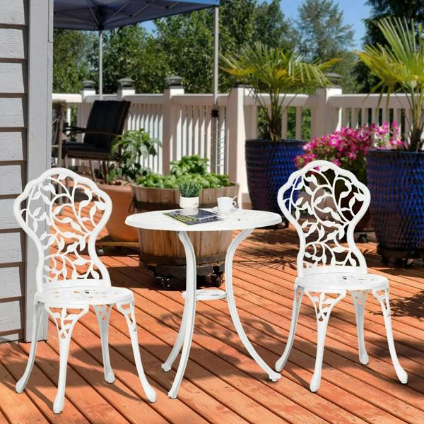 White round bistro table with two ornate cutout chairs for patio dining