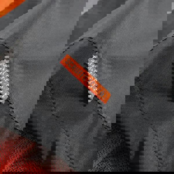 Scruffs Tech Mens Zip Up Work Warm Hooded Jacket Coat, close-up of the jacket's black fabric and orange tag with the Scruffs Eco logo.