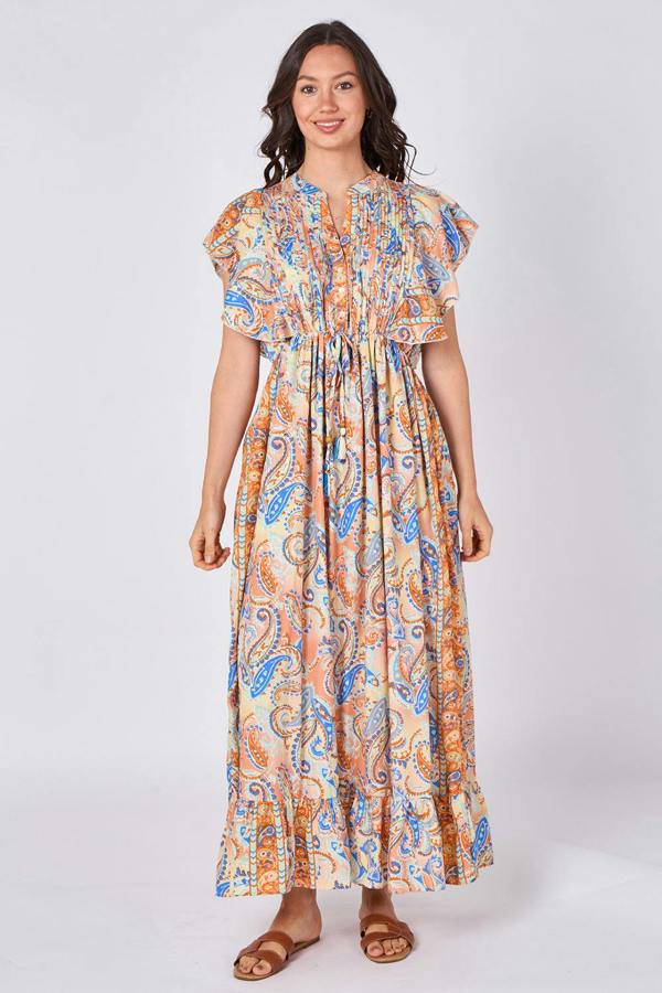 Woman wearing a patterned dress on a white background