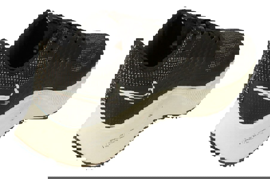 A back, right angle of the Nike Air Zoom Pegasus 38 Shields showcasing the waterproof tongue to keep the wearer insulated.