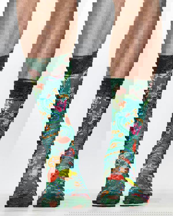 Colorful patterned socks worn by a person on a white background