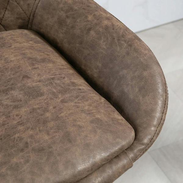 Brown faux leather seat edge close-up with diamond tufting and cushioned padding