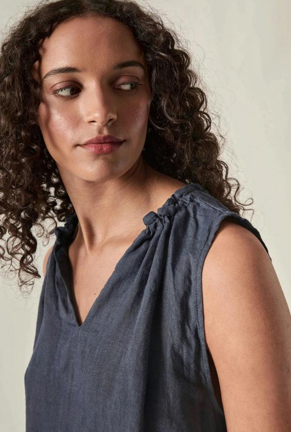 close up view of navy sleeveless v neck top by James Lakeland against soft beige background