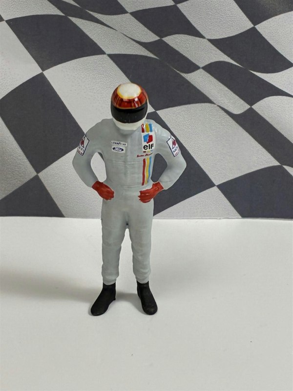 a toy figure in a race car suit