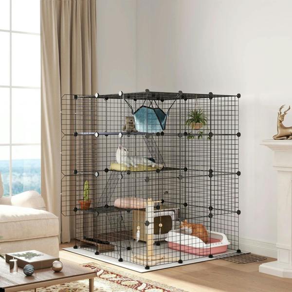 Black steel cat cage with hammock, ramps, and wire doors, multi-level indoor enclosure.