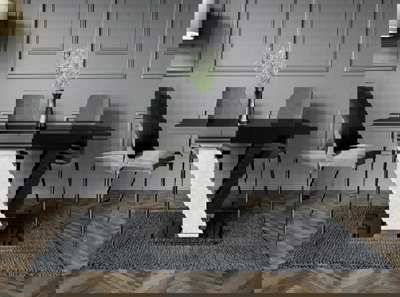 Dining room with a black dining table and chairs in a modern interior setting.