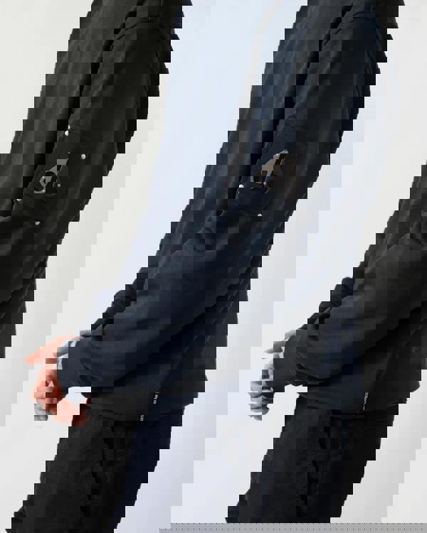 detail shot of a model wearing a Moose Knuckles Hartsfield Mens Crew Neck Sweatshirt in Navy 833