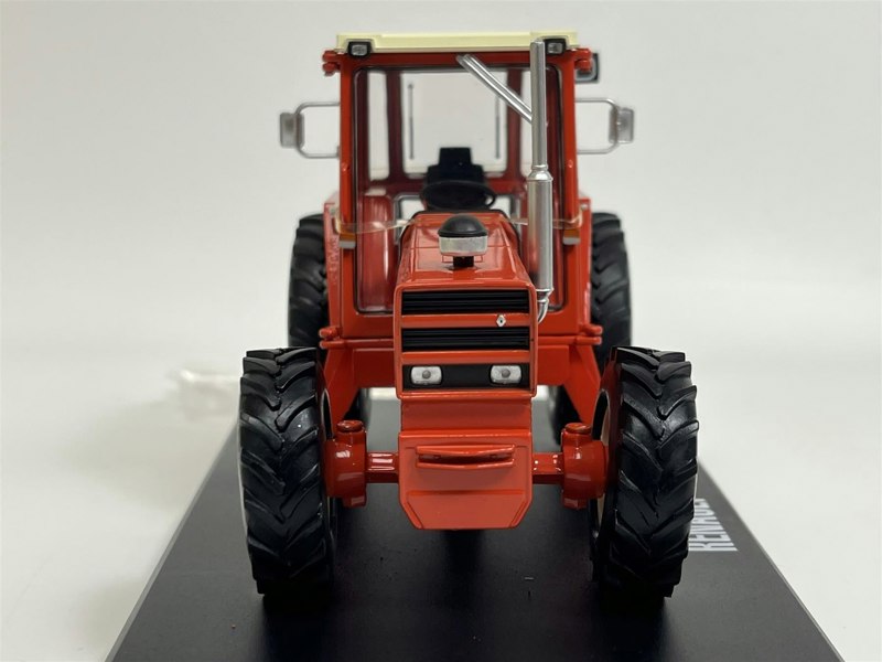 a red tractor on a black surface