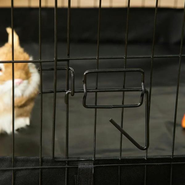 Small animal cage door latch and handle on black wire front panel