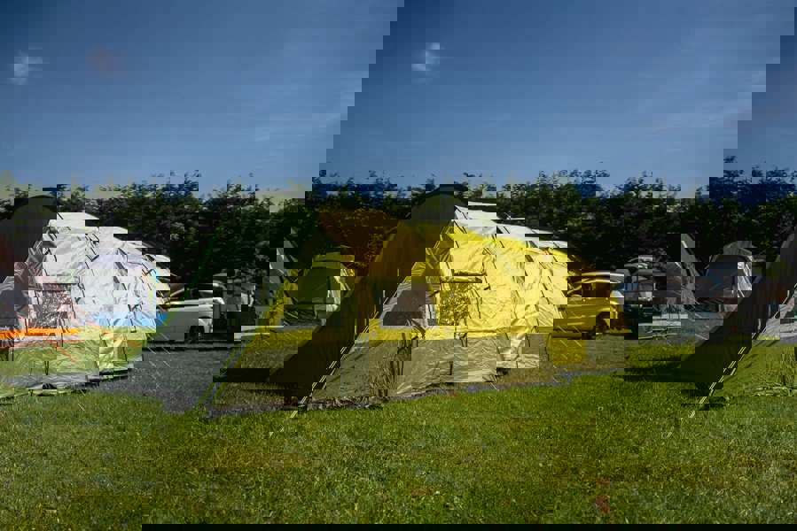 The Abberley XL 4 Berth Tent by OLPRO erected in a campsite with its doors closed.