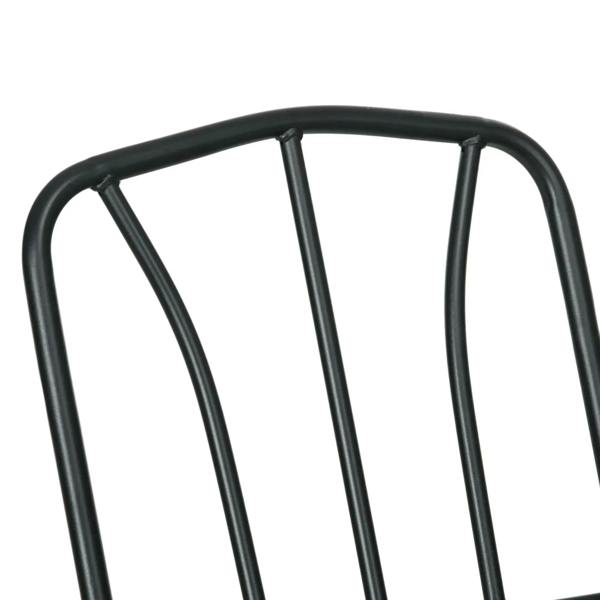 Close-up of dark metal armchair back frame with curved top